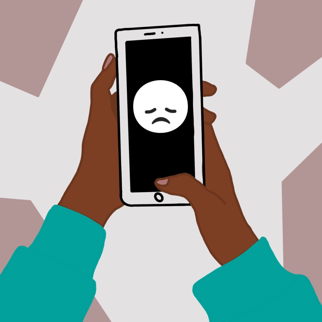 Sad face displayed on a phone. Associated with cyber-bullying