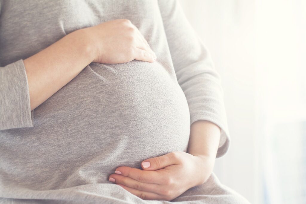 Anxiety while pregnant woman holding baby.